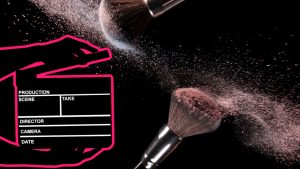 Makeup brushes with flying dust and a cinema clapper