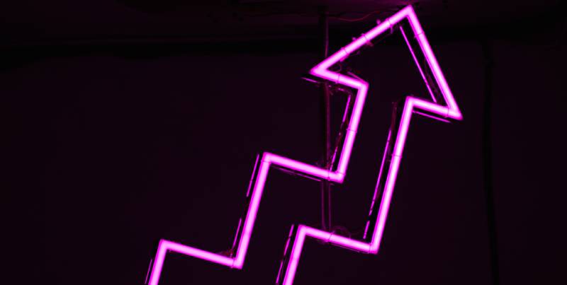 Pink neon arrow going up